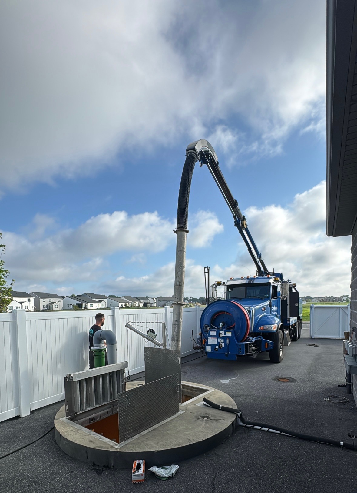 Crown Hydrovac truck using its extended boom at an open wet well