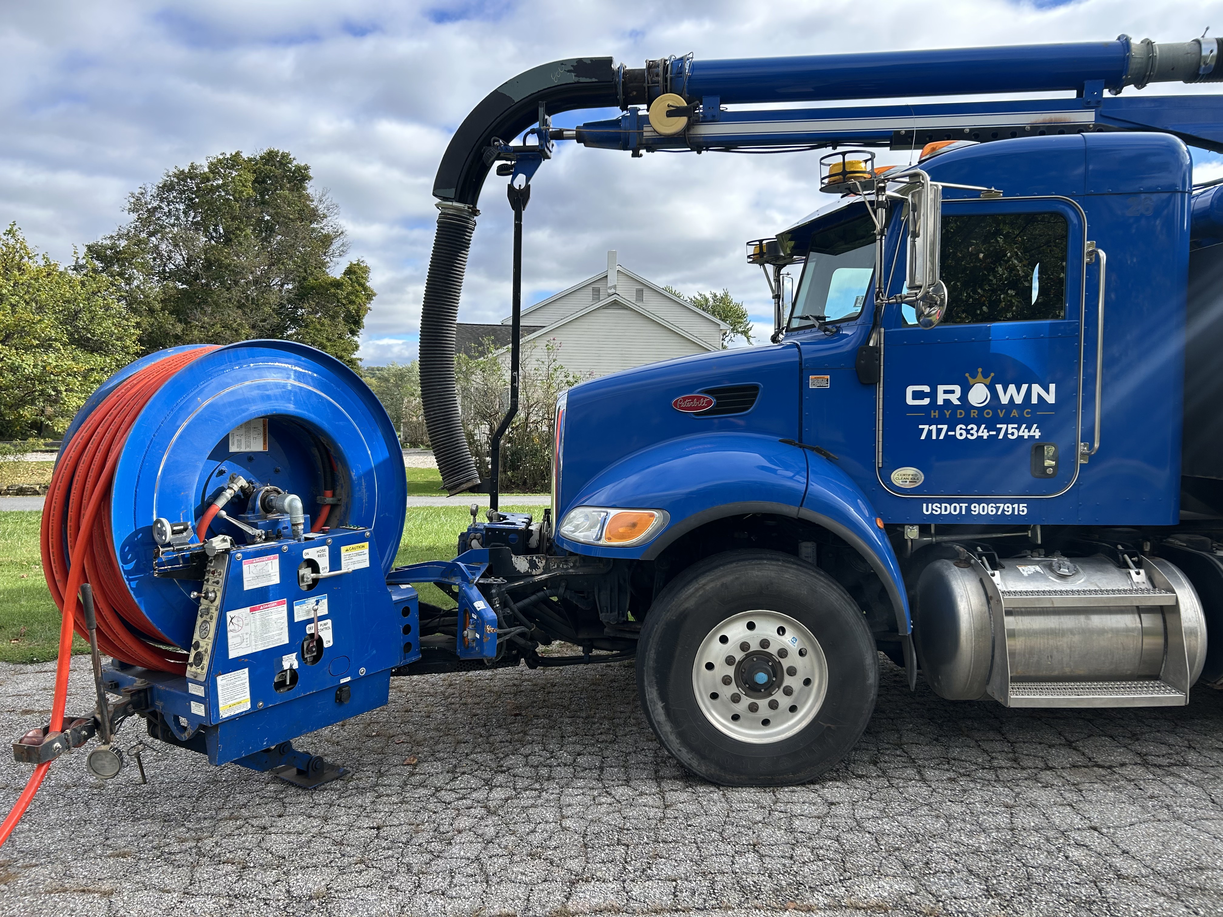 Front-mounted articulating jetter reel with high-pressure hose mounted on the front of the Crown Hydrovac truck